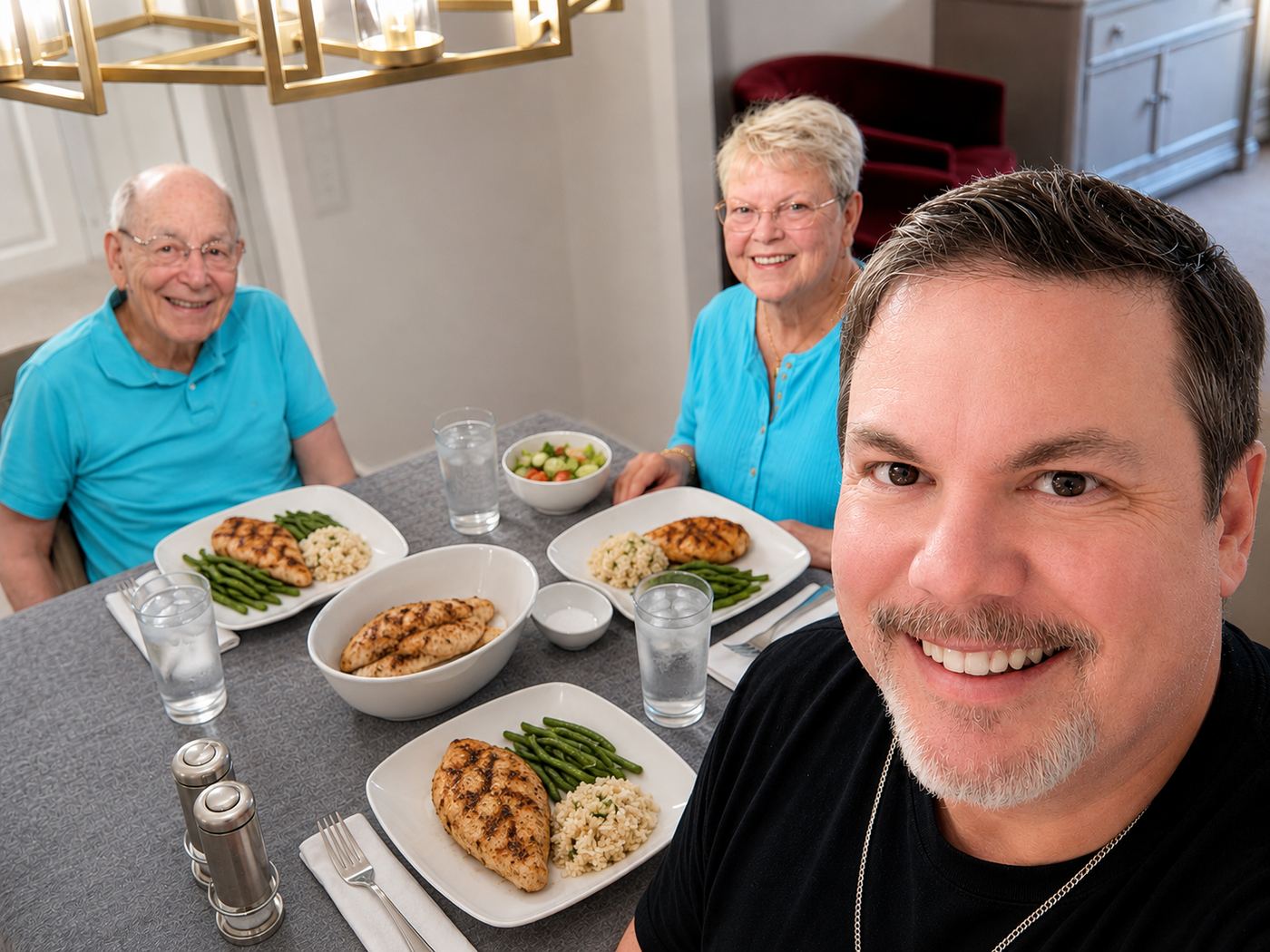 Thomas Christian with his mother and father, smiling around the family kitchen table